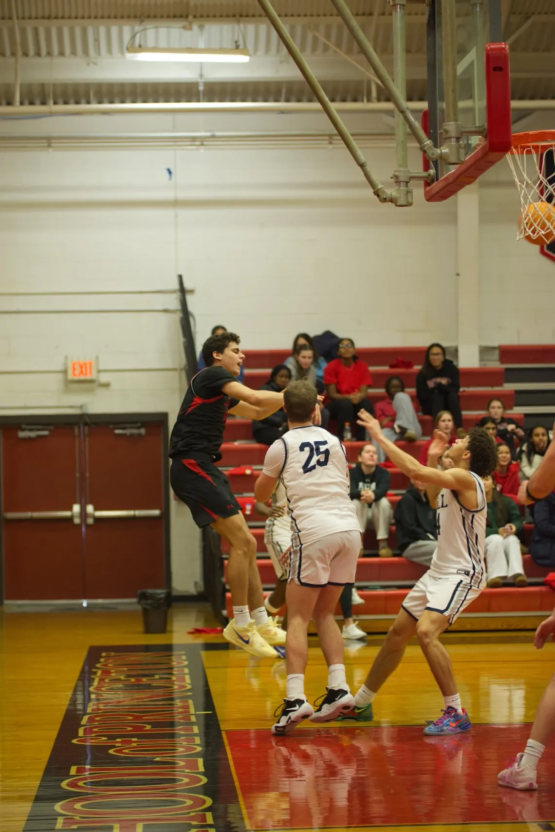 The Hun School's forward Jackson Cullert (10) shoots over The Hill School's guard Zane Conlon (25) during a high school basketball game in Princeton, NJ.
