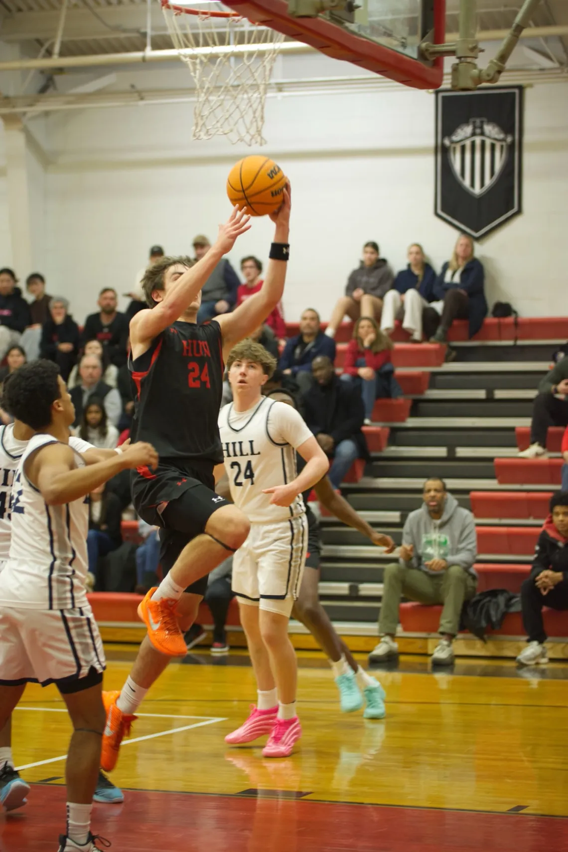 The Hun School's forward Julian Van Hoeck (24) drives to the basket against The Hill School's forward Joseph Terreri (24) during a high school basketball game in Princeton, NJ.