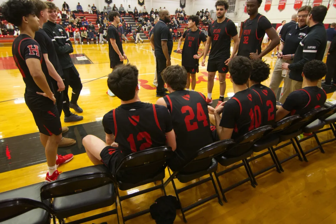 The Hun School of Princeton's varsity boys basketball team, in black and red jerseys.