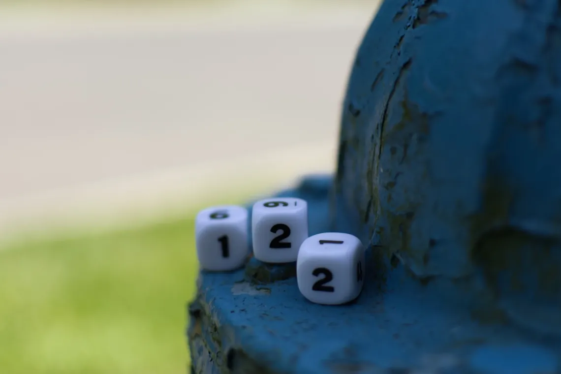 Three number dice ("122") are in shade, placed on the top of a blue fire hydrant.
